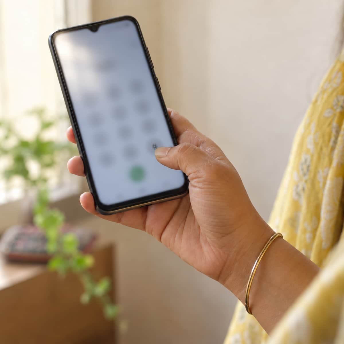 Hand holding a phone during a call